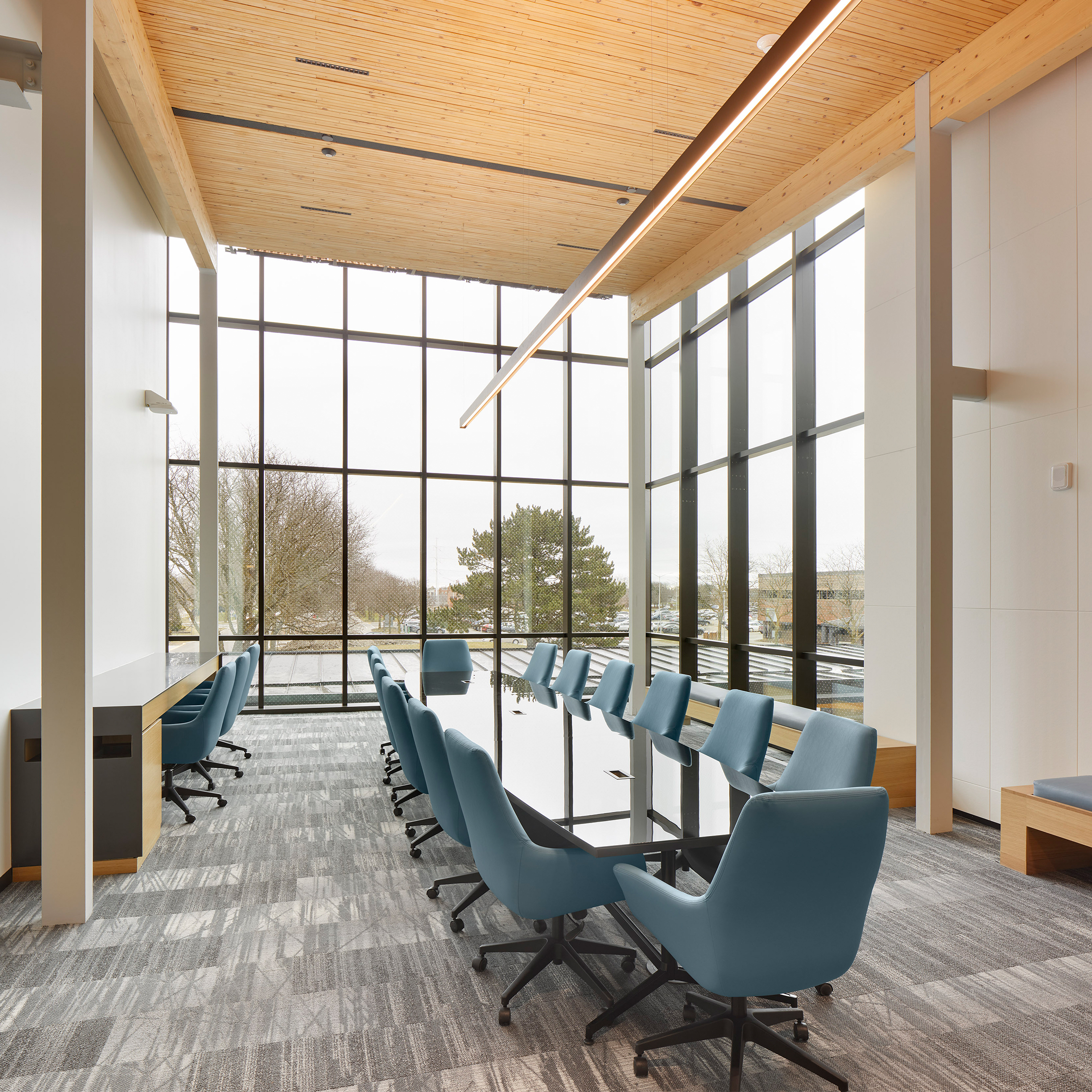 Large windowed room with a conference table in the centre.
