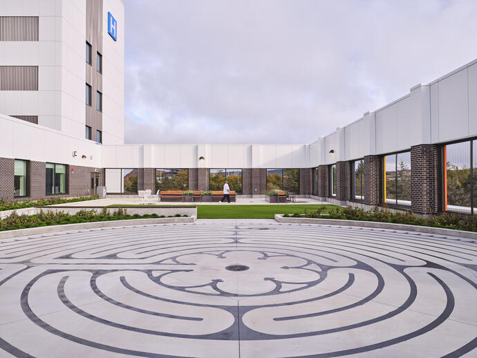 Outdoor area of the hospital with a tranquility walking path designed on the ground.