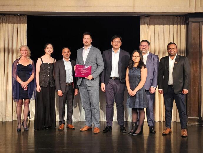 Members of the project team accept the award on stage.